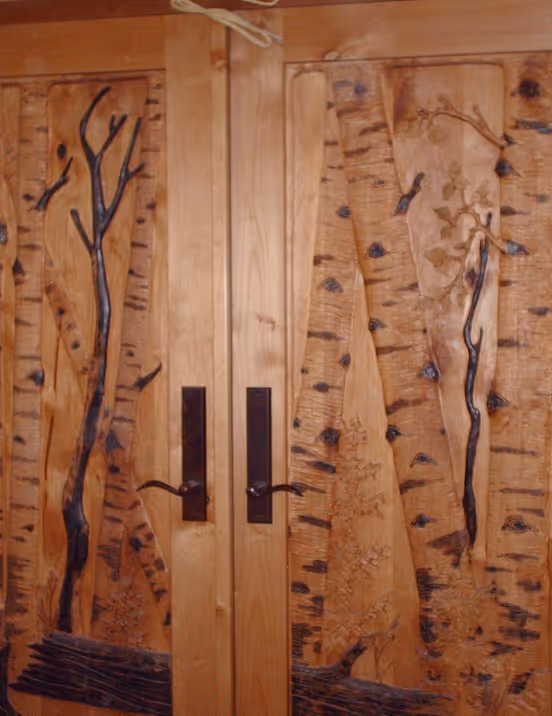 Hand carved aspen forest on door