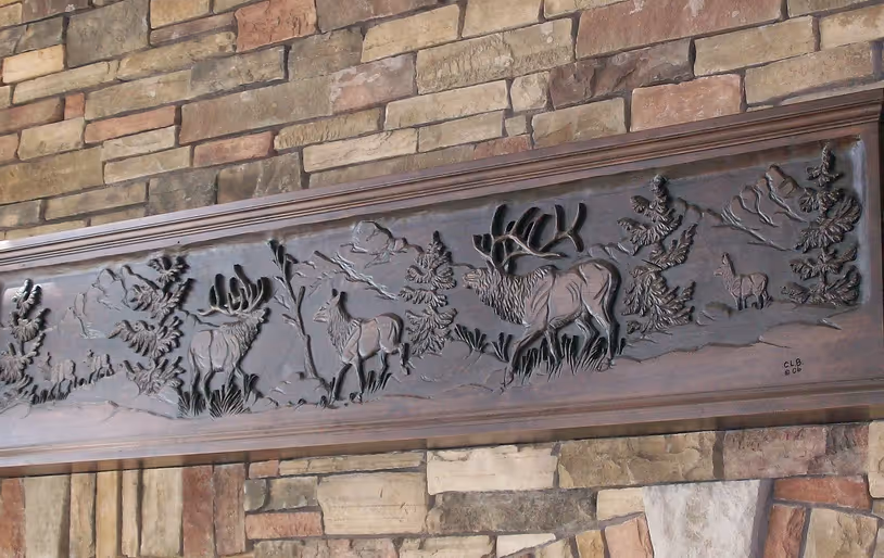 Hand carved elk scene on fireplace mantel